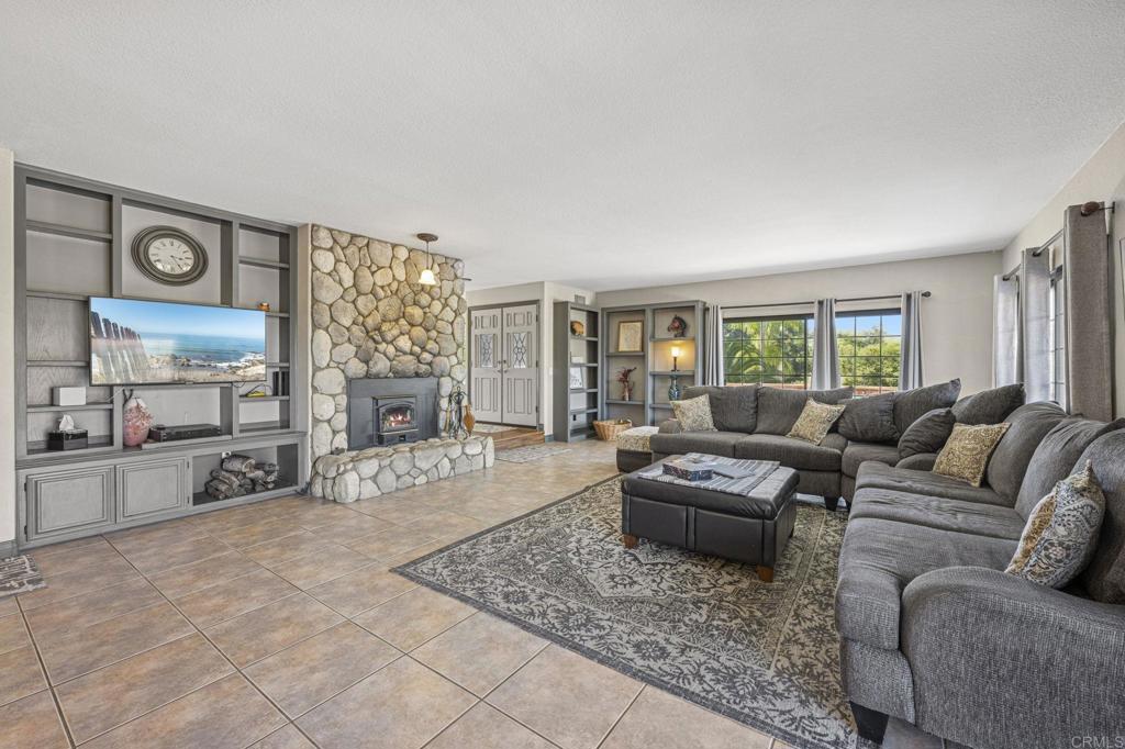3223 Olive Hill Road Fallbrook, CA 92028 - Photo 7 of 64 a living room with furniture and a flat screen tv