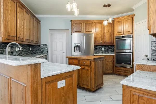 a kitchen with stainless steel appliances granite countertop a sink stove and refrigerator