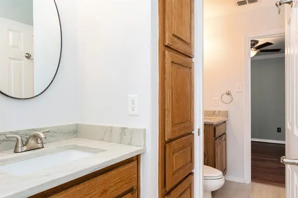 a bathroom with a granite countertop sink and a mirror
