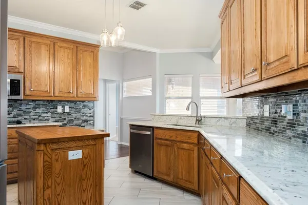 a kitchen with stainless steel appliances granite countertop a sink stove and cabinets