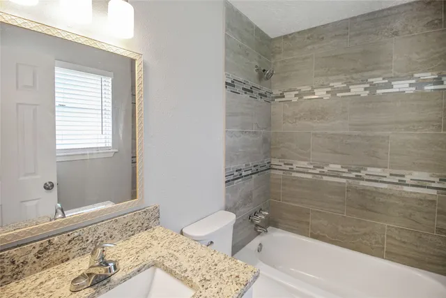 a bathroom with a bathtub and shower