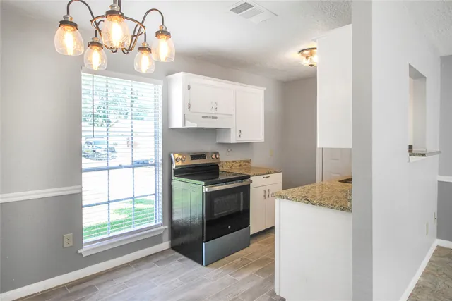 a kitchen with a stove and a window