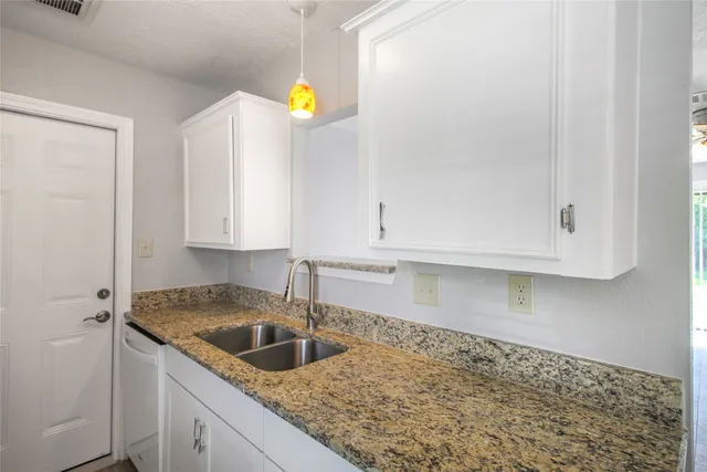 a kitchen with a sink and cabinets