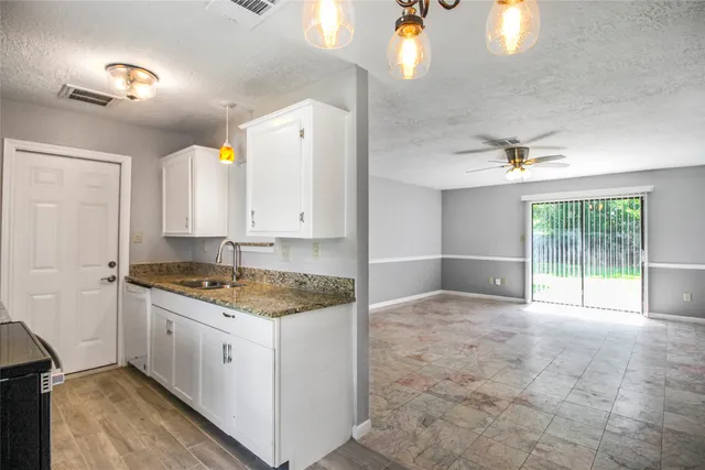 a kitchen with a stove a faucet and a refrigerator