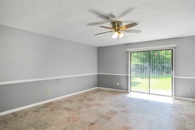 a view of a livingroom with a ceiling fan and window