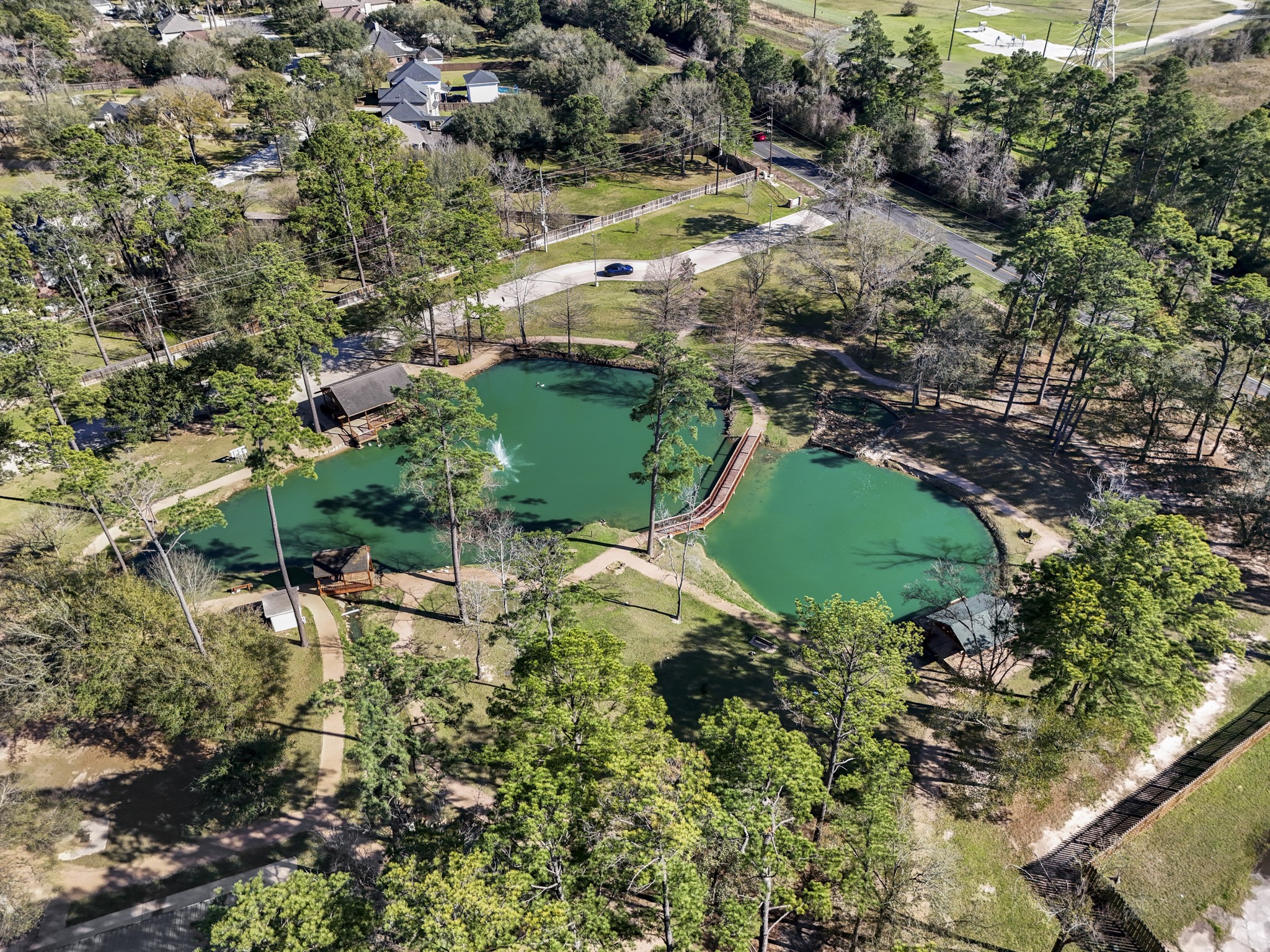 6303 Larkmount Drive Spring, TX 77389 - Photo 49 of 50 Moving closer into Northampton’s amenity setting, the neighborhood’s outdoor lifestyle comes into focus with lakes, green space, and recreation areas woven into the trees. It’s a strong reminder that life here extends beyond the home, with community spaces nearby for getting outside, gathering, and enjoying the established Northampton setting.