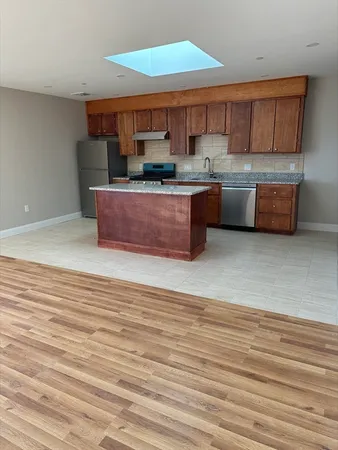 a kitchen with stainless steel appliances granite countertop a sink and cabinets
