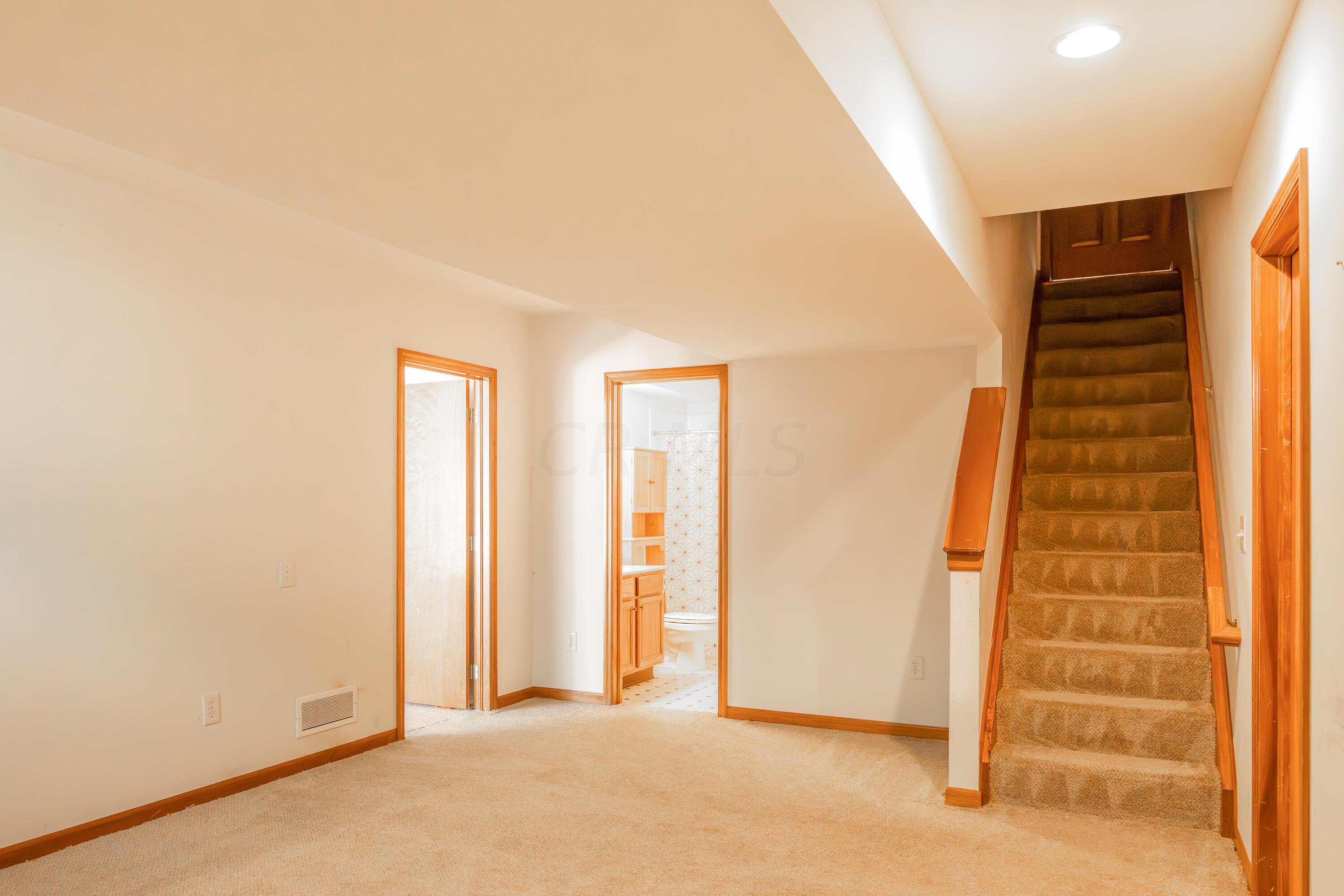 7168 Linworth Road Columbus, OH 43235 - Photo 24 of 34 Entertainment room includes an entrance to the expansive unfinished/storage area of the basement