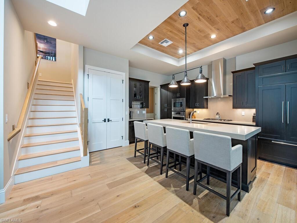 9200 Mercato Way Naples, FL 34108 - Photo 6 of 13 a view of a dining room with furniture window and wooden floor