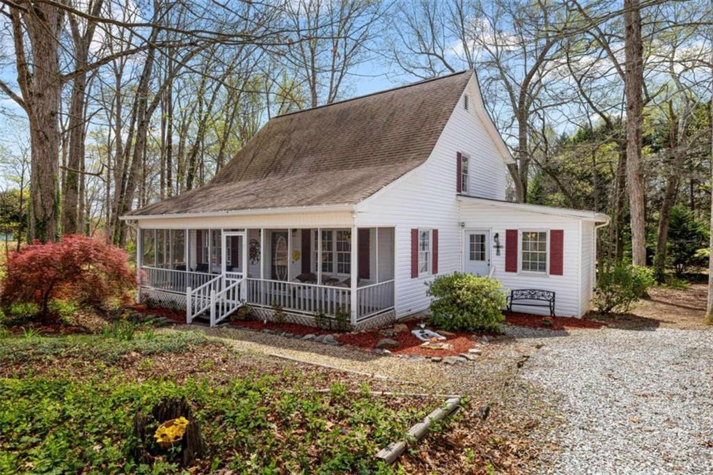 4255 Holly Springs Road Pendergrass, GA 30567 - Photo 1 of 1 a view of a house with a yard and large trees