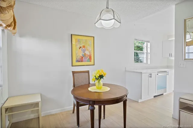 a view of a dining room with a table and chairs