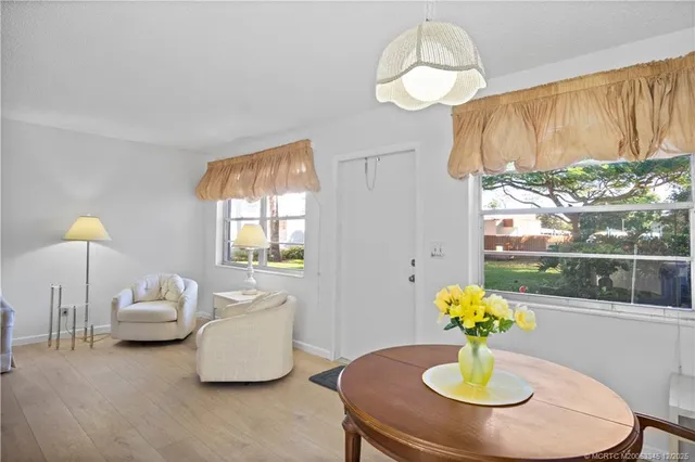 a dining room with furniture and chandelier