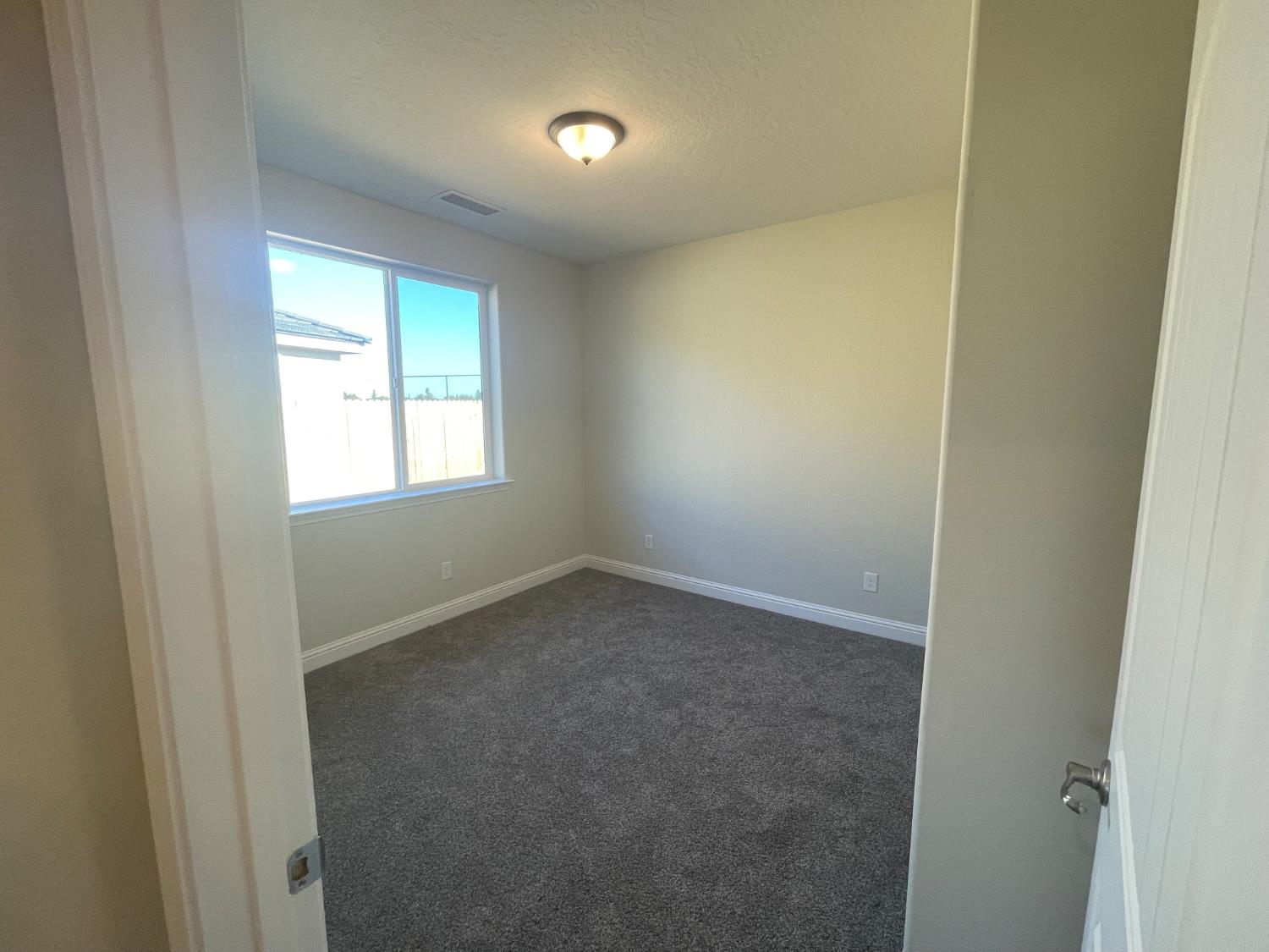 16171 West Monterey Avenue Kerman, CA 93630 - Photo 11 of 19 an empty room with a window