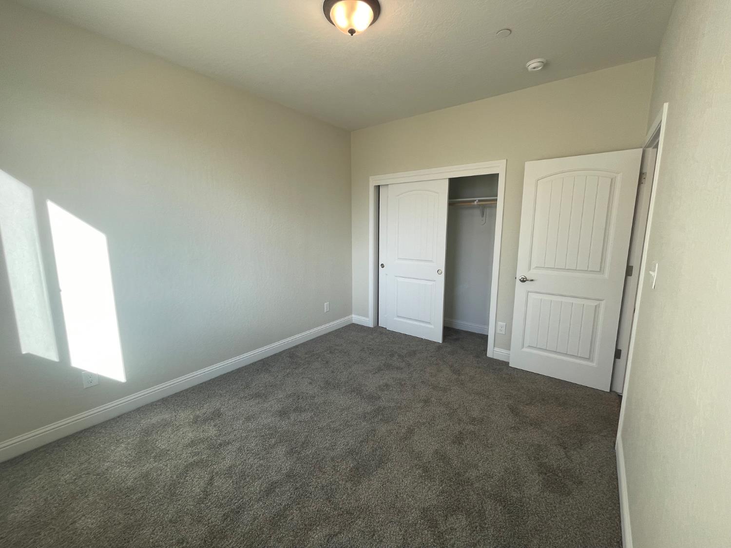 16171 West Monterey Avenue Kerman, CA 93630 - Photo 17 of 20 an empty room with windows and closet
