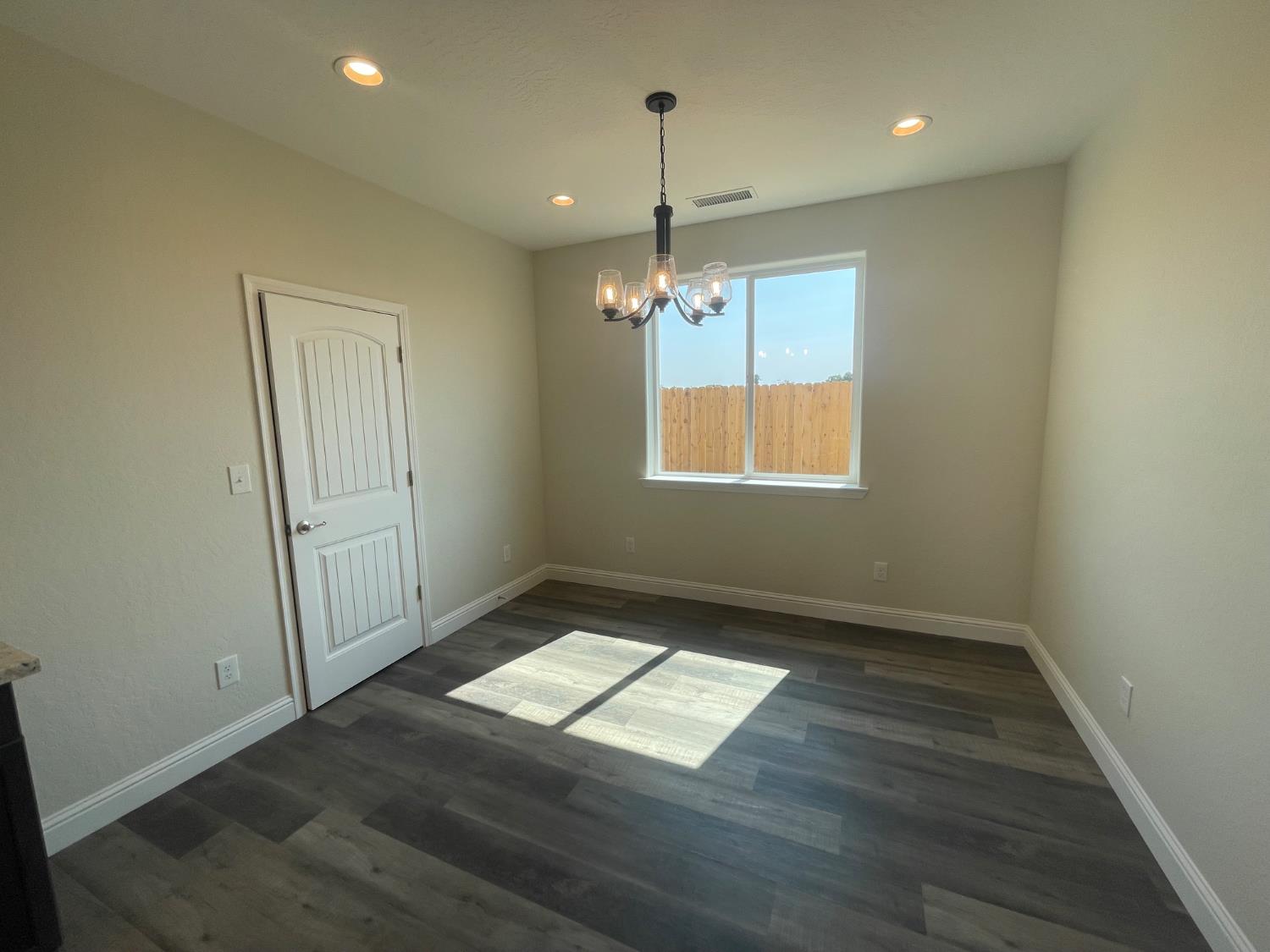 16171 West Monterey Avenue Kerman, CA 93630 - Photo 19 of 19 an empty room with wooden floor and windows