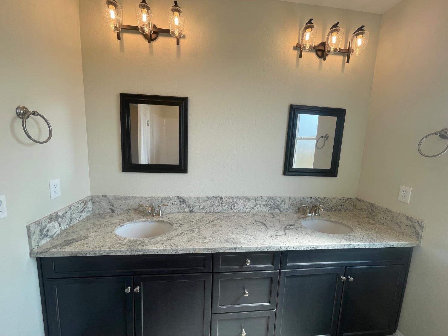 16171 West Monterey Avenue Kerman, CA 93630 - Photo 2 of 19 a bathroom with a sink and a mirror