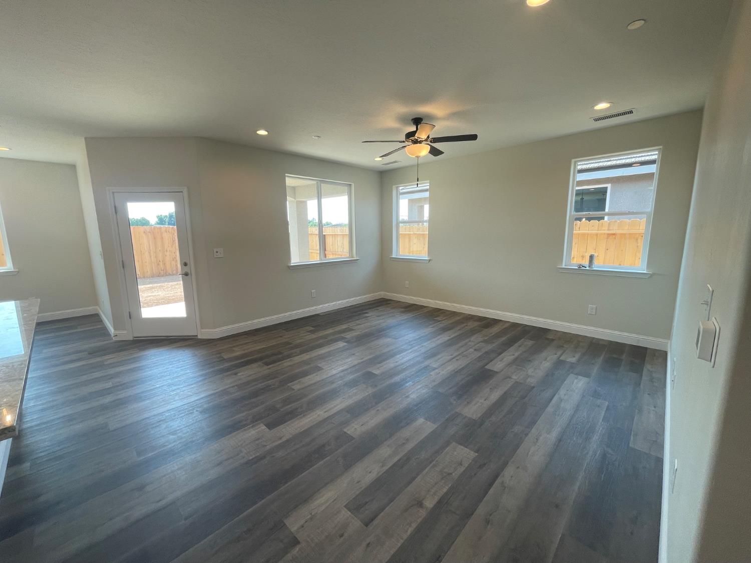 16171 West Monterey Avenue Kerman, CA 93630 - Photo 6 of 20 a view of an empty room with a window and wooden floor