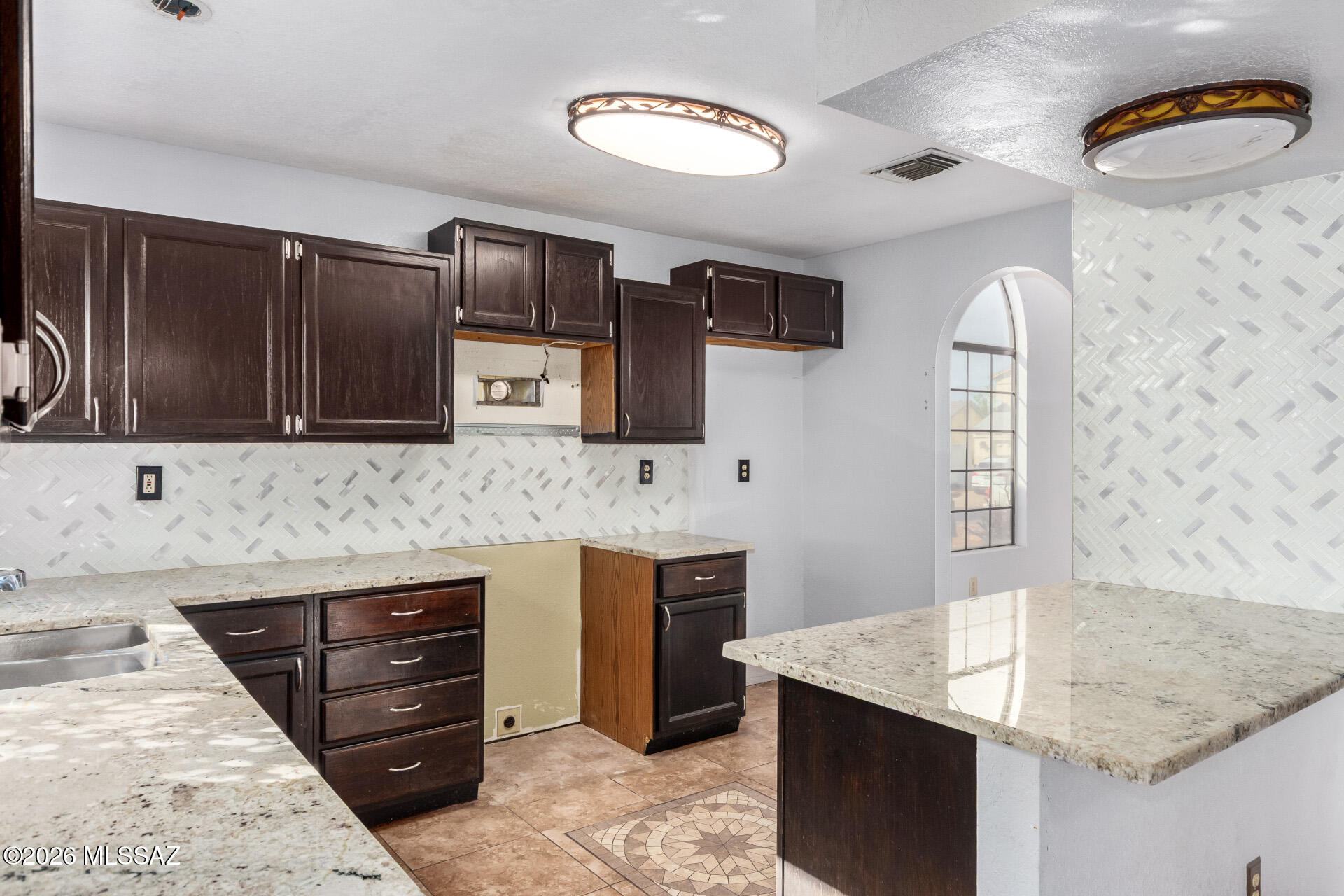 5331 West Eaglestone Loop Tucson, AZ 85742 - Photo 14 of 35 a kitchen with stainless steel appliances granite countertop a sink stove and oven