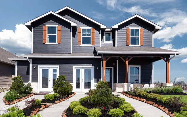a front view of a house with garden