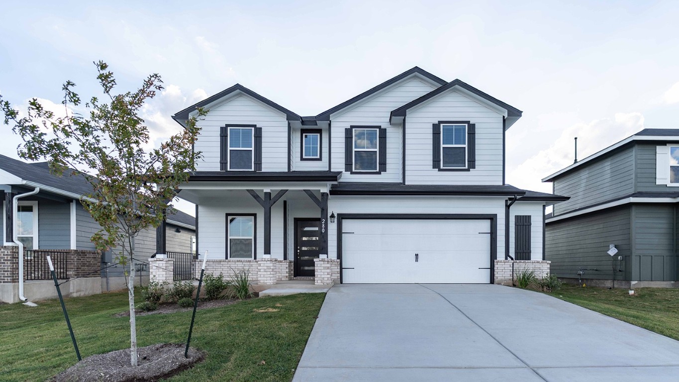 280 Yosemite Drive Kyle, TX 78640 - Photo 1 of 18 a front view of a house with a garden and plants