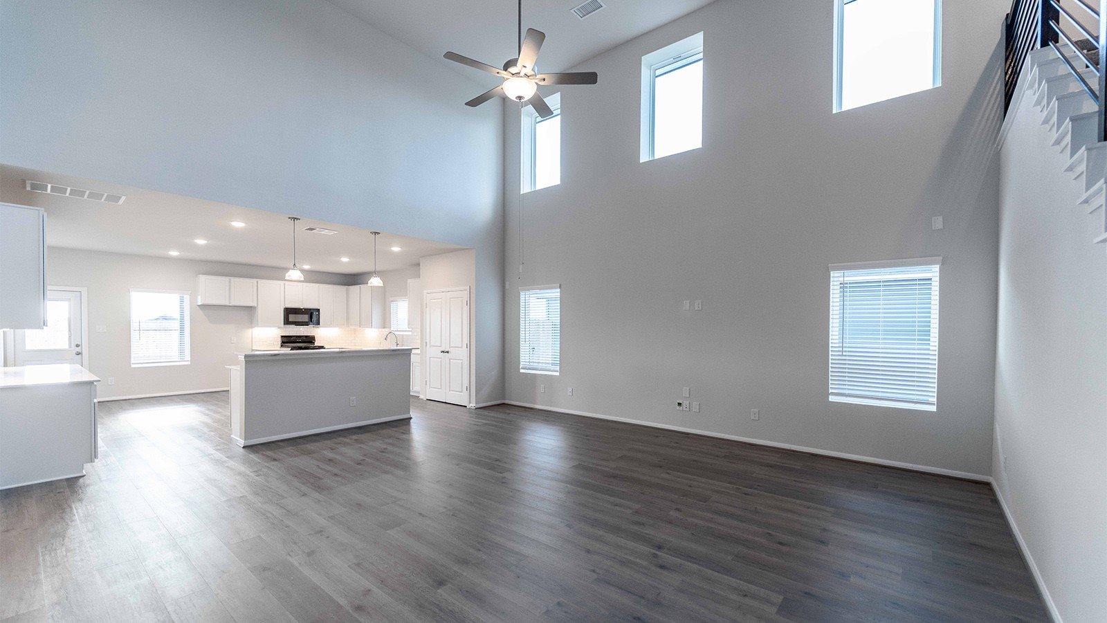 280 Yosemite Drive Kyle, TX 78640 - Photo 14 of 18 a view of large windows and a kitchen with wooden floor