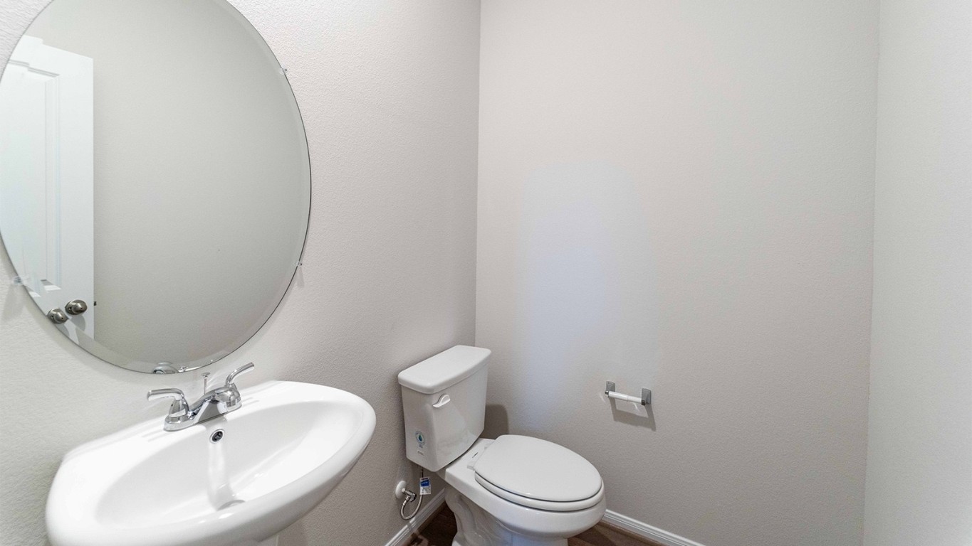 280 Yosemite Drive Kyle, TX 78640 - Photo 15 of 18 a bathroom with a toilet a sink and mirror
