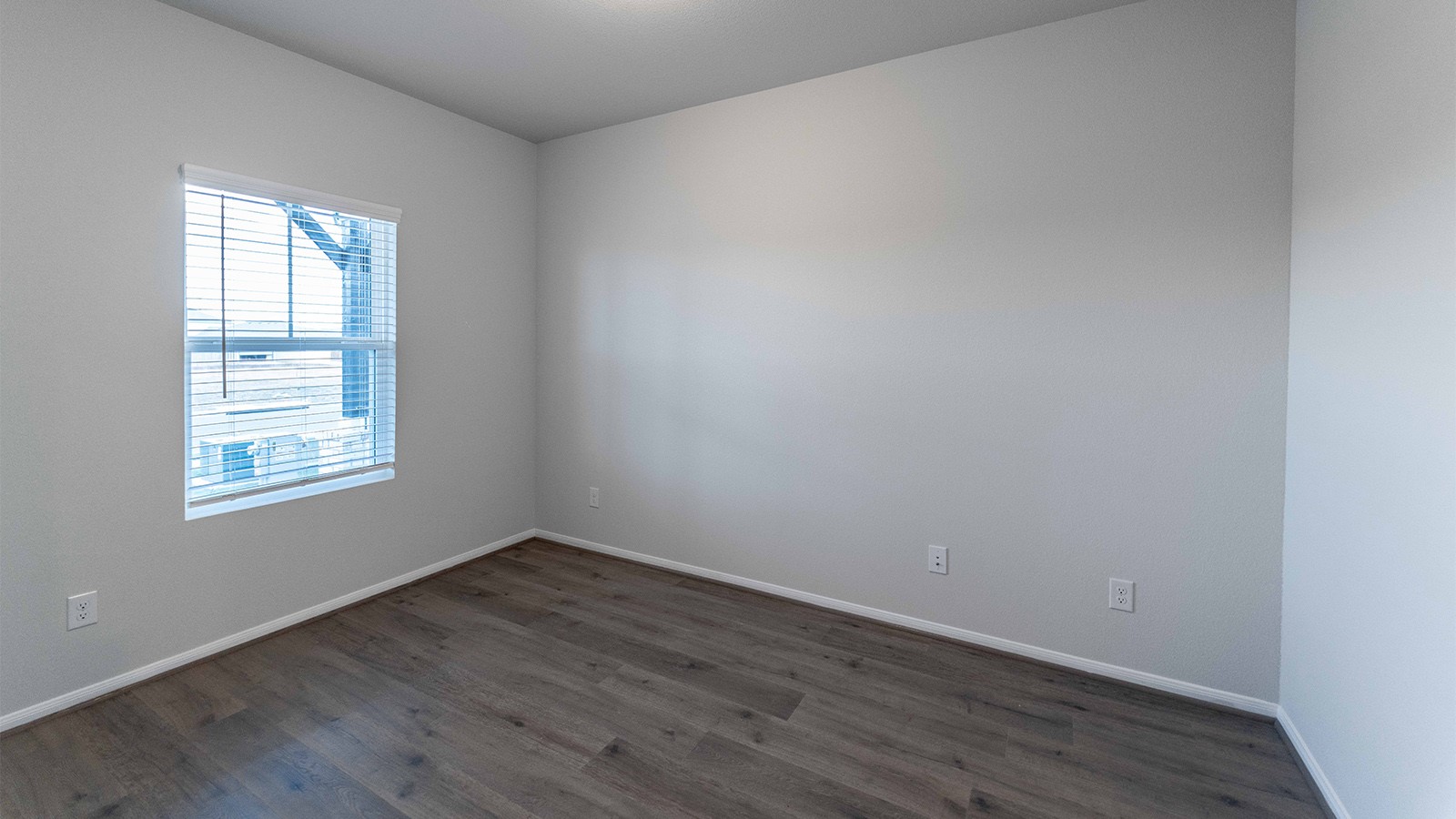 280 Yosemite Drive Kyle, TX 78640 - Photo 17 of 18 an empty room with wooden floor and windows