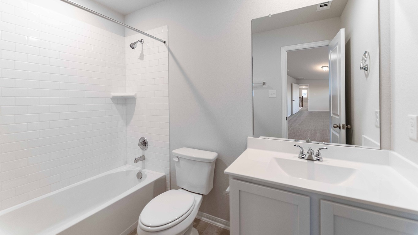 280 Yosemite Drive Kyle, TX 78640 - Photo 2 of 18 a bathroom with a sink toilet and shower