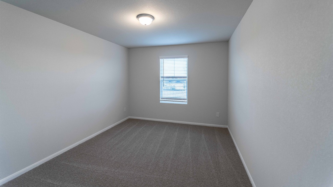 280 Yosemite Drive Kyle, TX 78640 - Photo 5 of 18 an empty room with a window