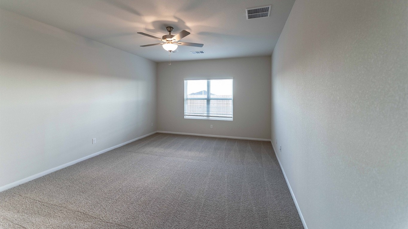 280 Yosemite Drive Kyle, TX 78640 - Photo 7 of 18 an empty room with windows and chandelier fan