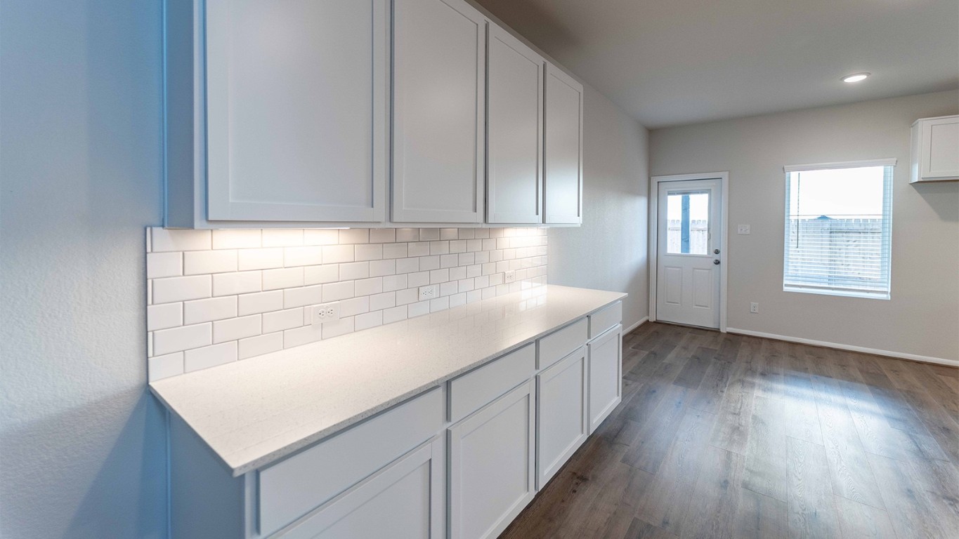 280 Yosemite Drive Kyle, TX 78640 - Photo 10 of 18 an empty room with wooden floor and window