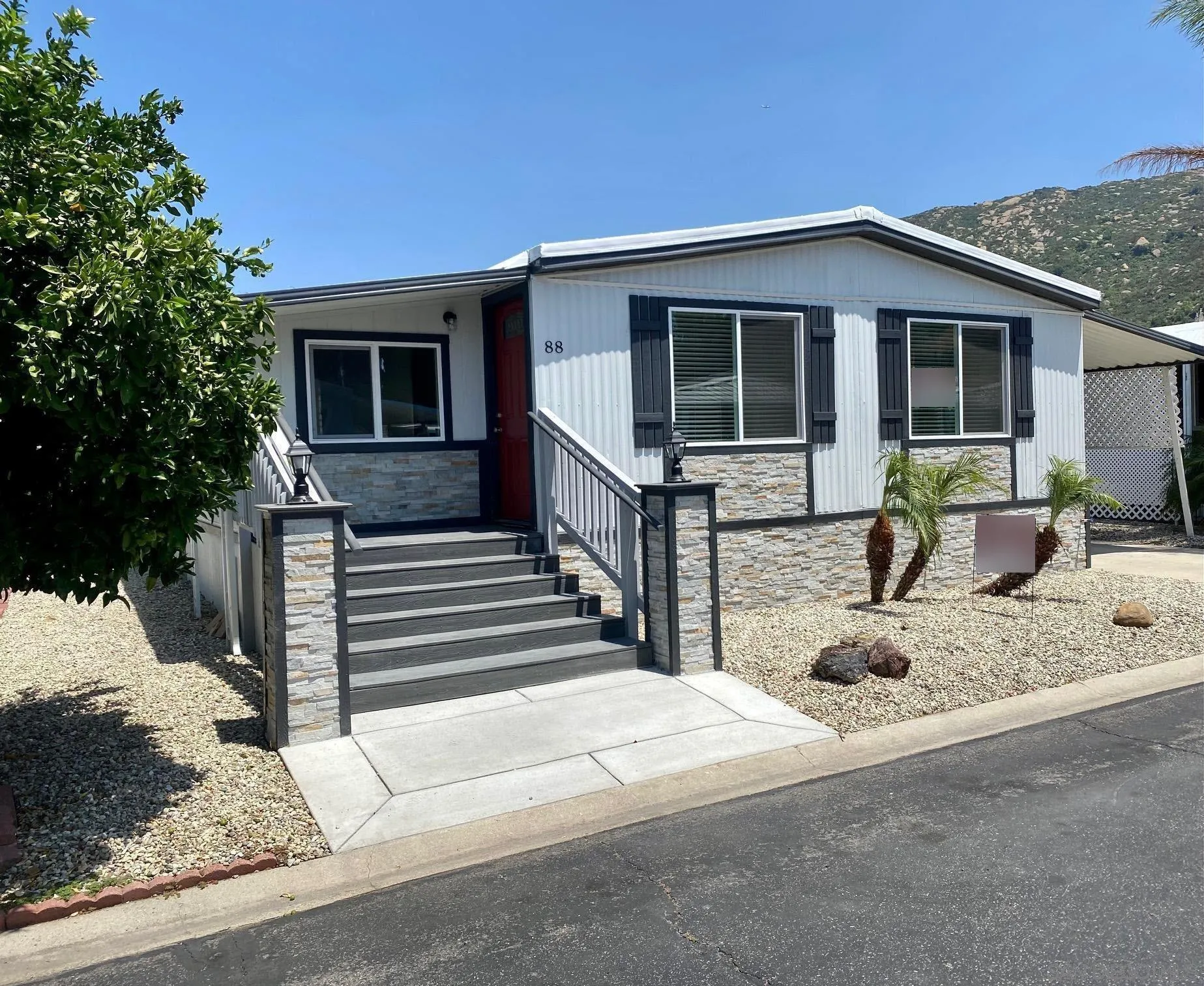 6480 Katherine Road, Unit 88 Simi Valley, CA 93063 - Photo 1 of 15 a front view of a house with garden