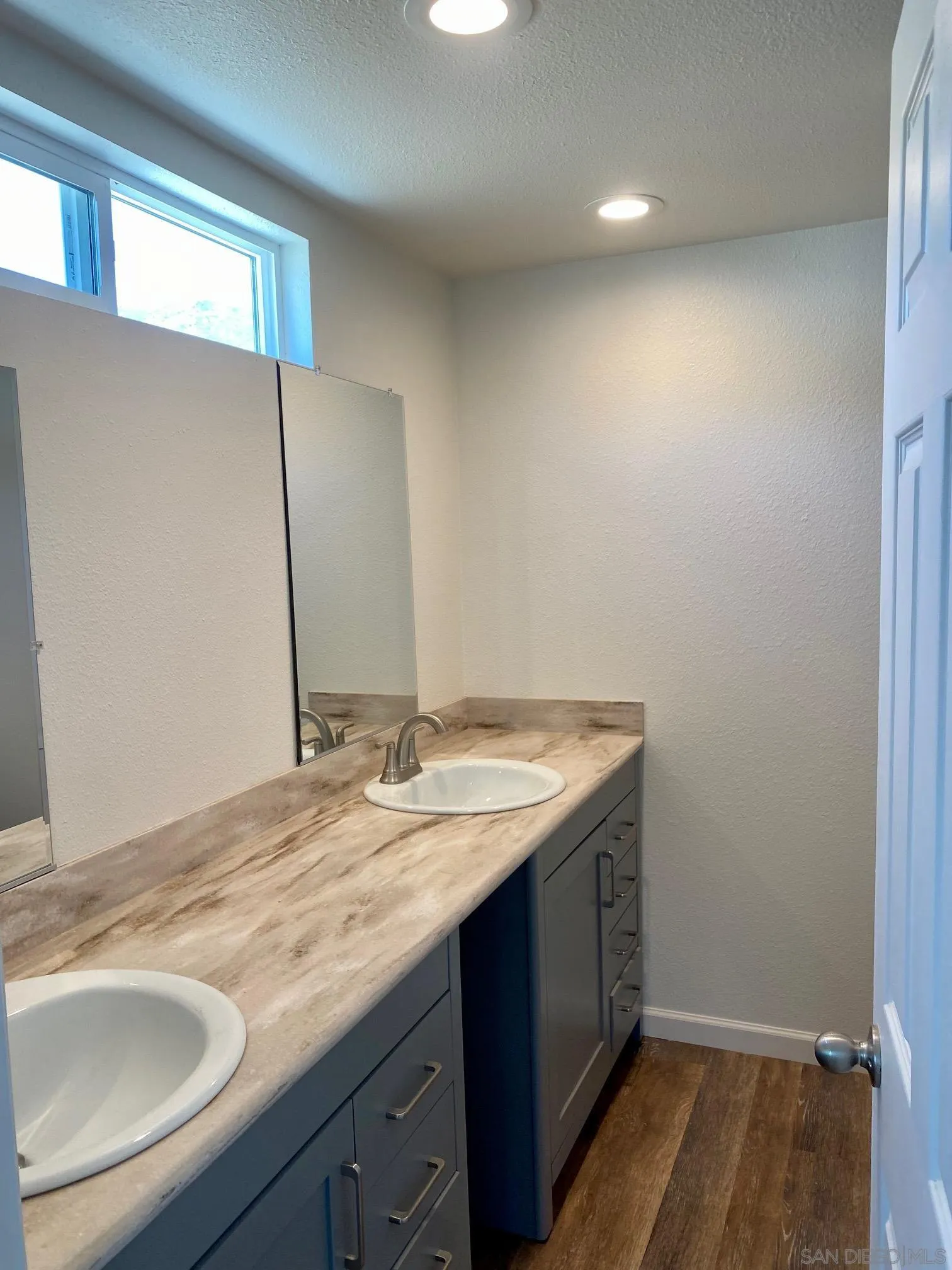 6480 Katherine Road, Unit 88 Simi Valley, CA 93063 - Photo 13 of 15 a bathroom with a granite countertop sink and a mirror