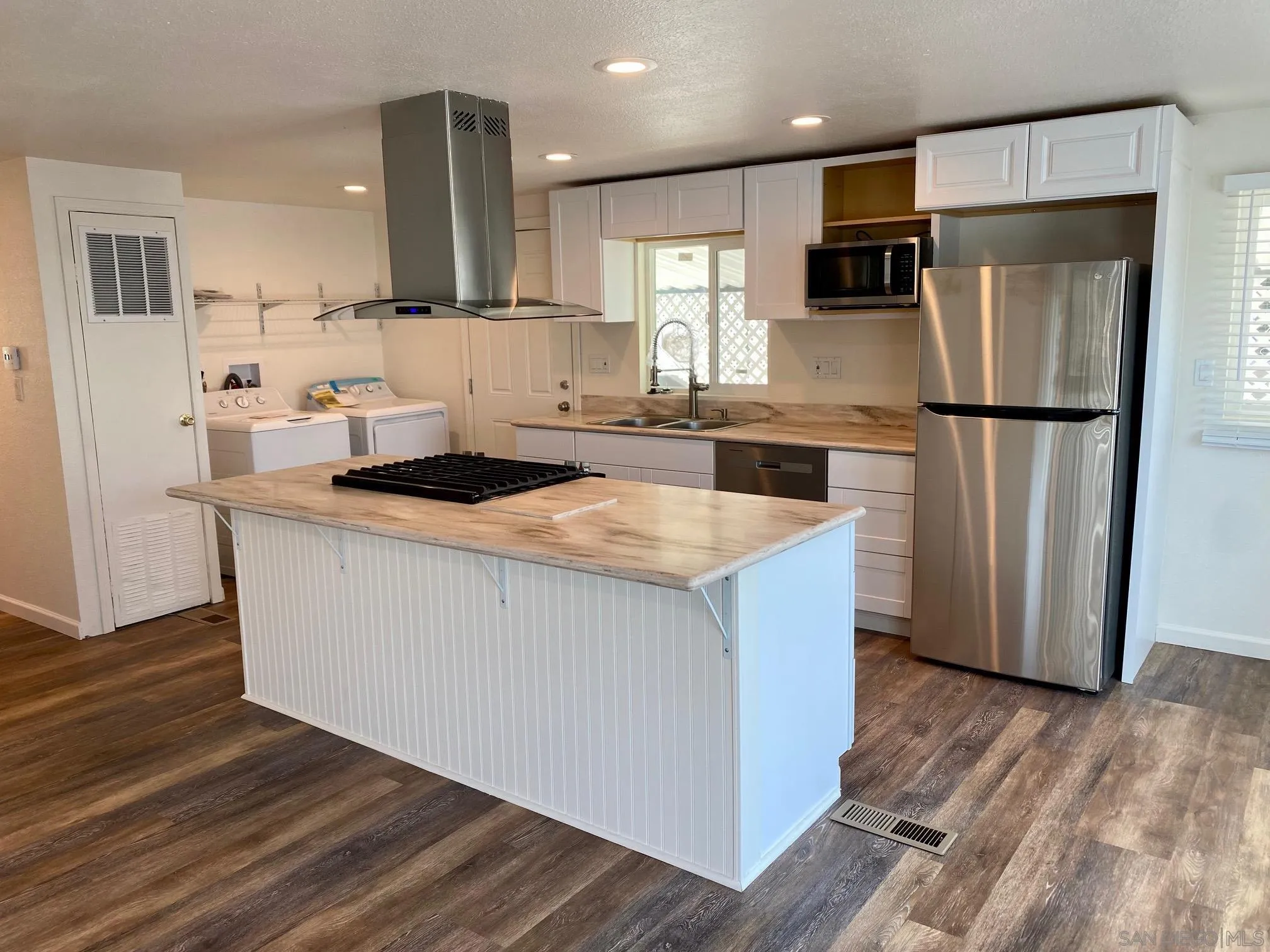 6480 Katherine Road, Unit 88 Simi Valley, CA 93063 - Photo 4 of 15 a kitchen with stainless steel appliances a refrigerator sink and wooden floor