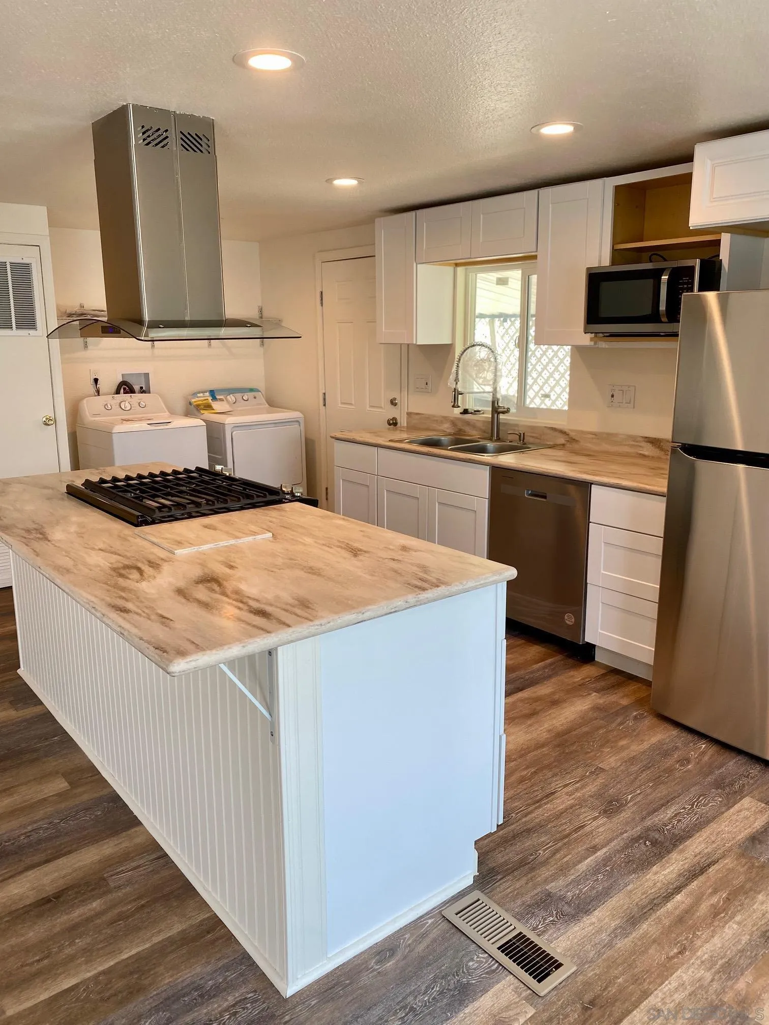 6480 Katherine Road, Unit 88 Simi Valley, CA 93063 - Photo 5 of 15 a kitchen with stainless steel appliances kitchen island granite countertop a stove a sink and a refrigerator