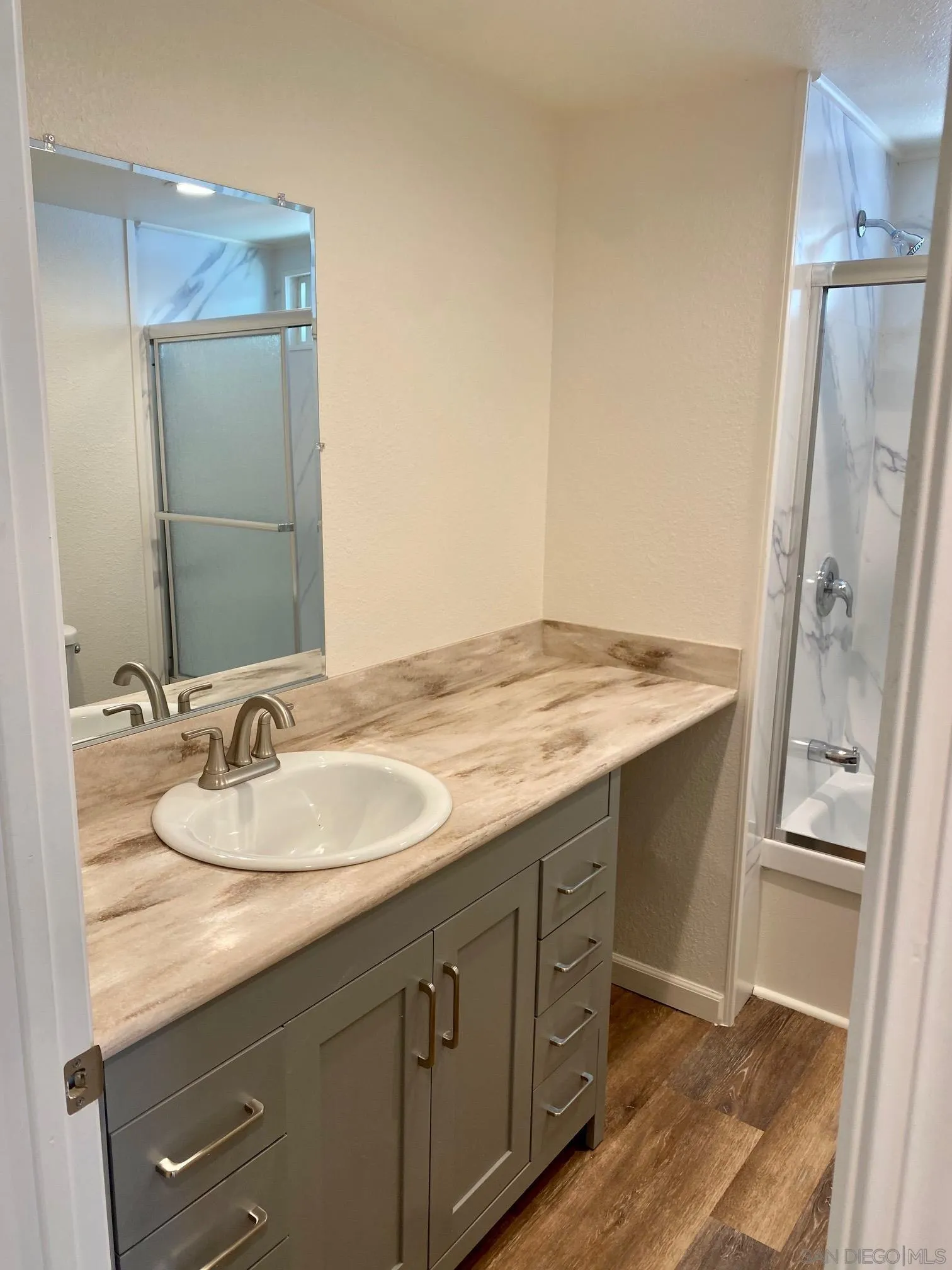 6480 Katherine Road, Unit 88 Simi Valley, CA 93063 - Photo 8 of 15 a bathroom with a granite countertop sink and a mirror
