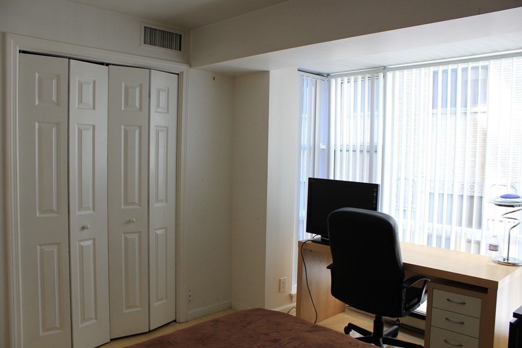 170 Tremont Street, Unit 606 Boston, MA 02111 - Photo 11 of 19 a view of a workspace with furniture and a window