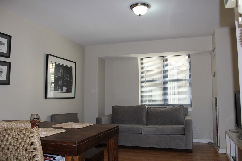 170 Tremont Street, Unit 606 Boston, MA 02111 - Photo 12 of 19 a living room with furniture and a window