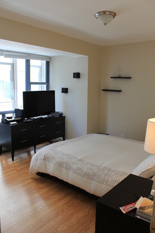 170 Tremont Street, Unit 606 Boston, MA 02111 - Photo 13 of 19 a bedroom with a bed and a window