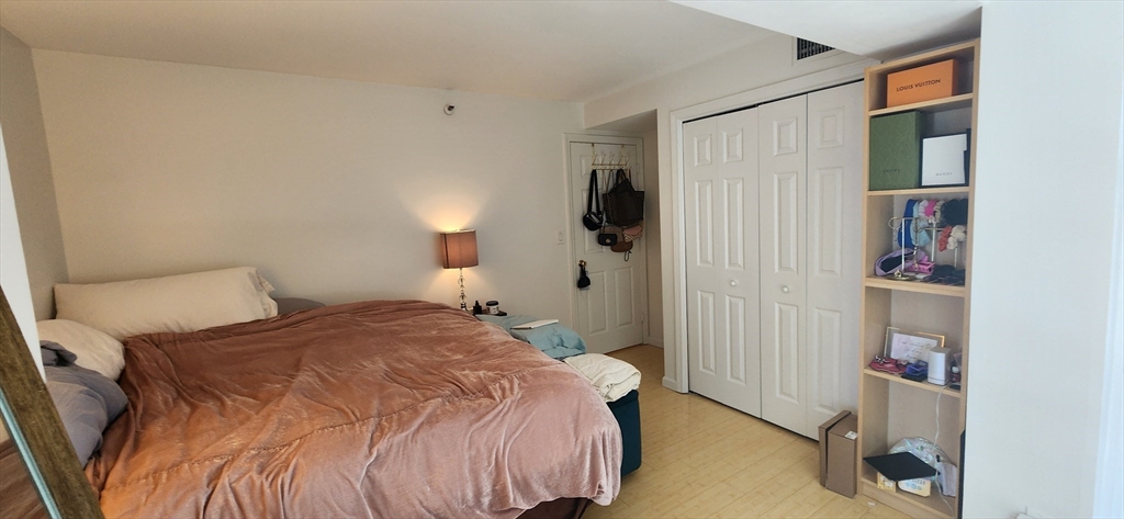 170 Tremont Street, Unit 606 Boston, MA 02111 - Photo 6 of 19 a bedroom with a bed and a closet