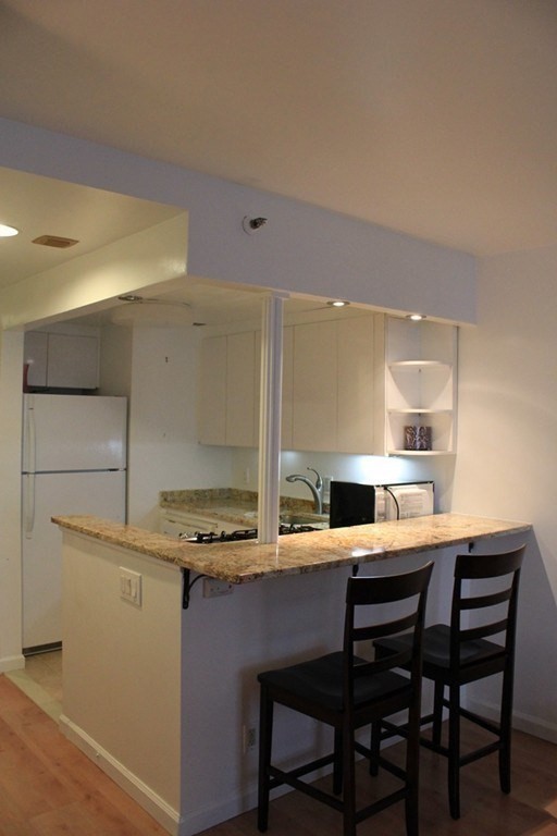 170 Tremont Street, Unit 606 Boston, MA 02111 - Photo 9 of 19 a kitchen with a table and chairs in it