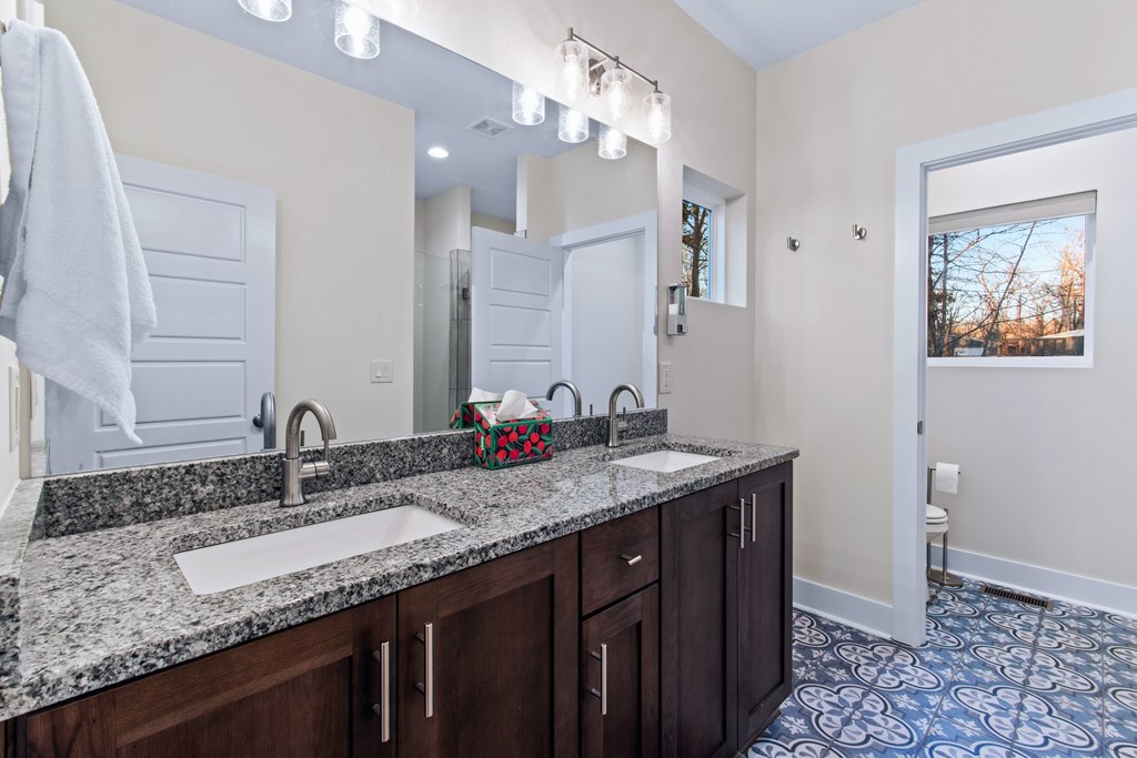 1001 Sunset Road Epworth, GA 30541 - Photo 20 of 36 a bathroom with a granite countertop sink a large mirror and vanity