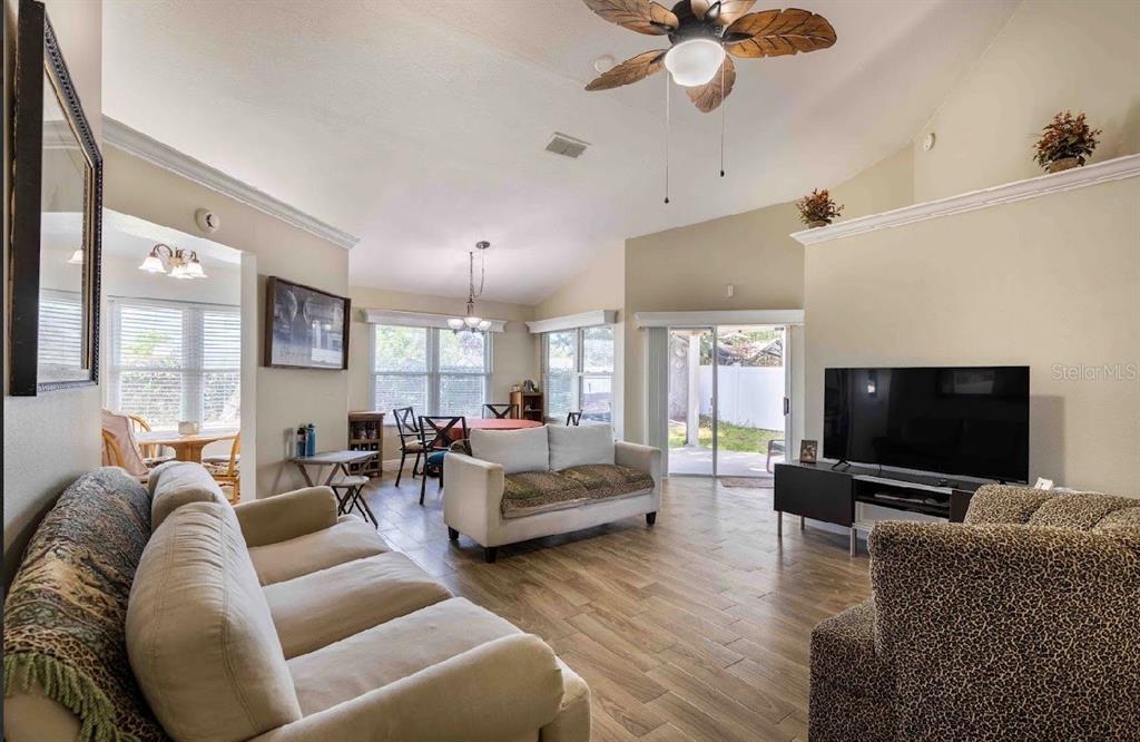 10665 Huntridge Road Orlando, FL 32825 - Photo 4 of 12 a living room with furniture and a flat screen tv