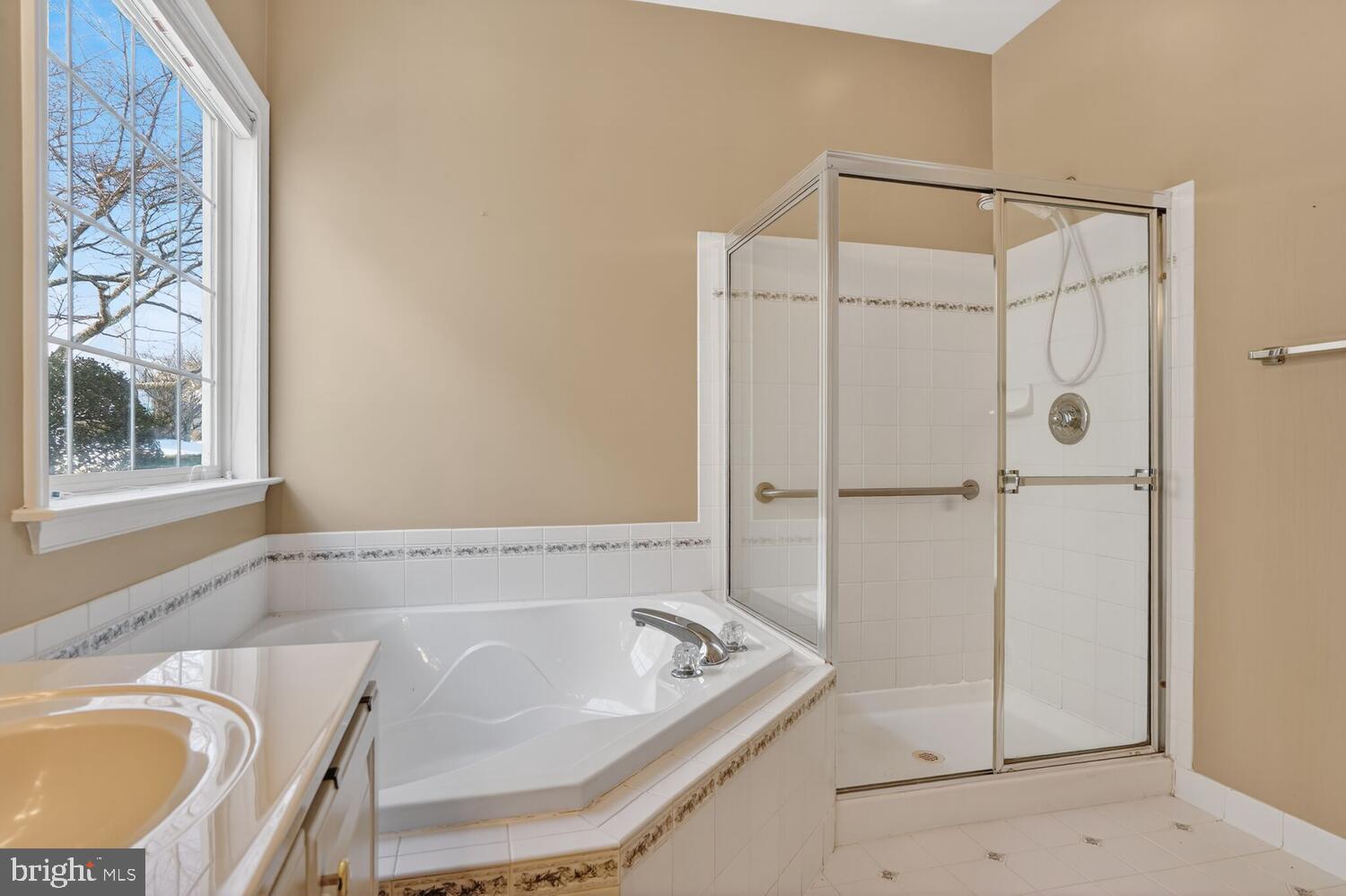 6767 Derby Run Way Gainesville, VA 20155 - Photo 14 of 37 a bathroom with a tub a sink and a shower