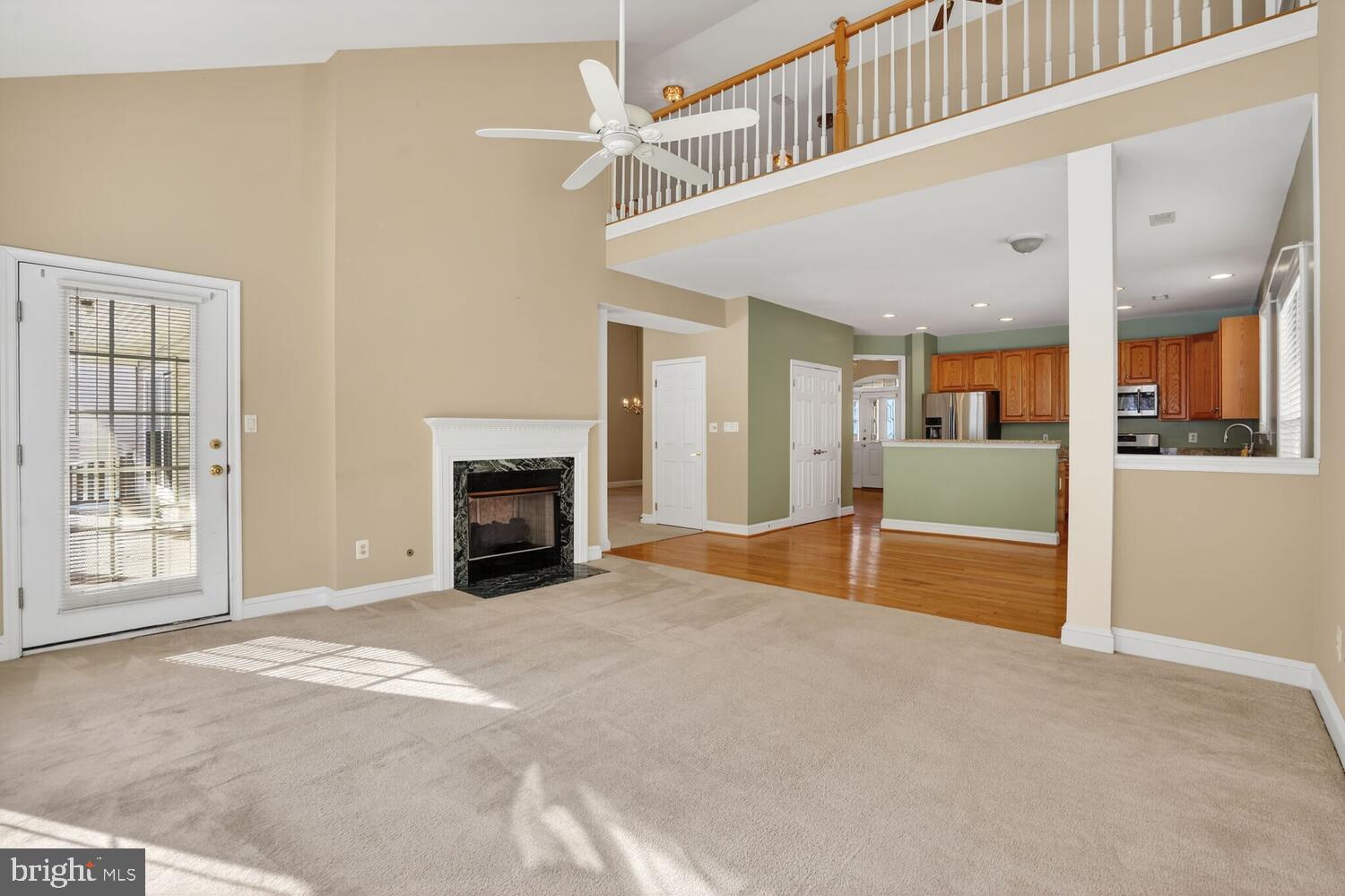 6767 Derby Run Way Gainesville, VA 20155 - Photo 4 of 37 a view of an empty room with a fireplace and a window