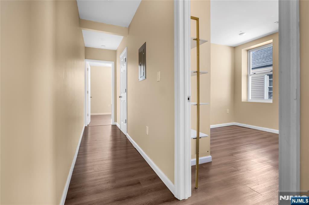 183 Bergen Turnpike Ridgefield Park, NJ 07660 - Photo 11 of 18 a view of a hallway with wooden floor and staircase