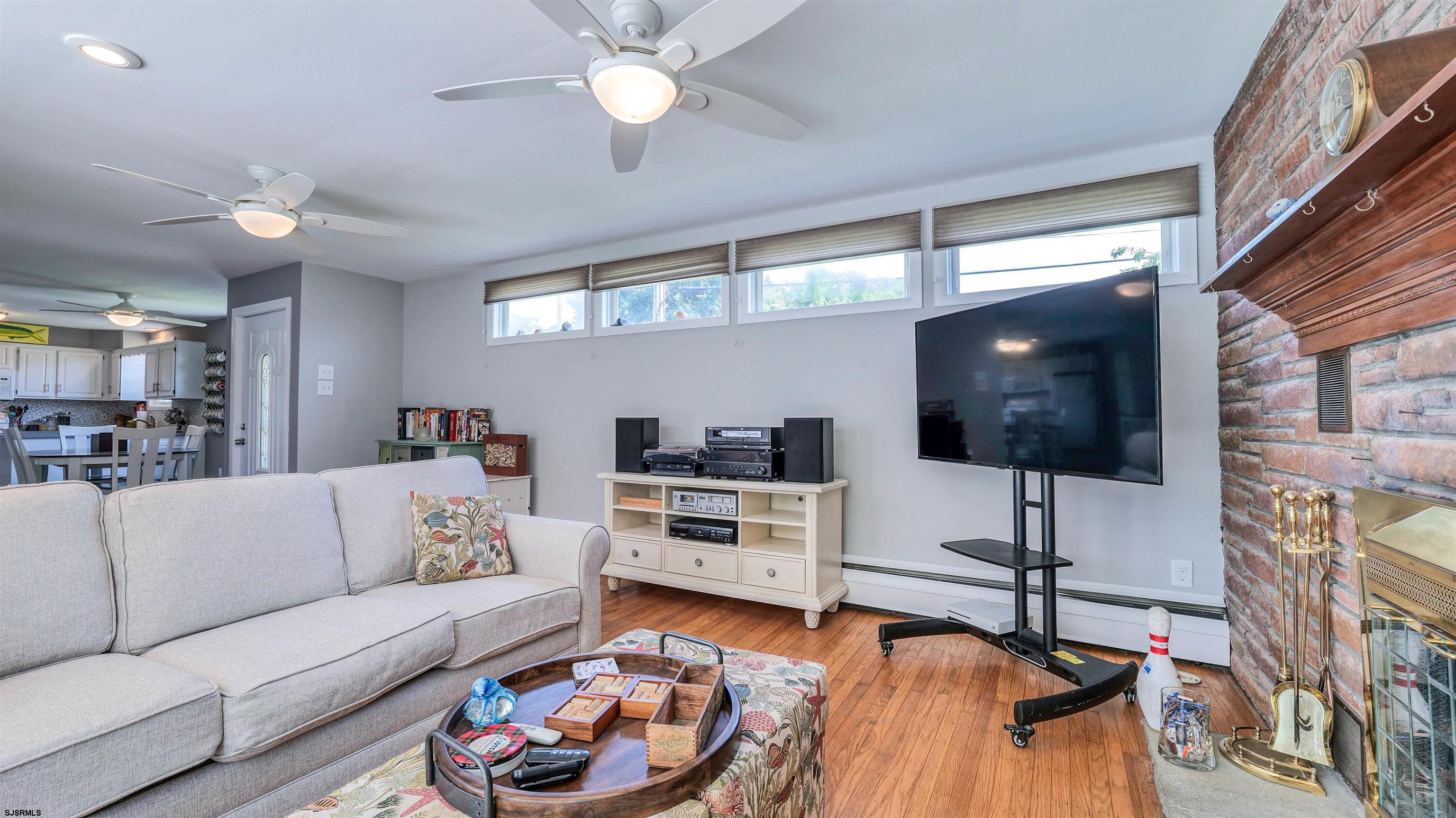 100 West Mill Road Northfield, NJ 08225 - Photo 7 of 33 a living room with furniture and a flat screen tv