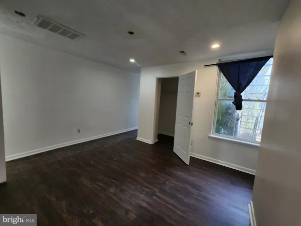 a view of walk in closet with clothes