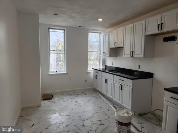 a kitchen with stainless steel appliances a refrigerator a stove a microwave and cabinets