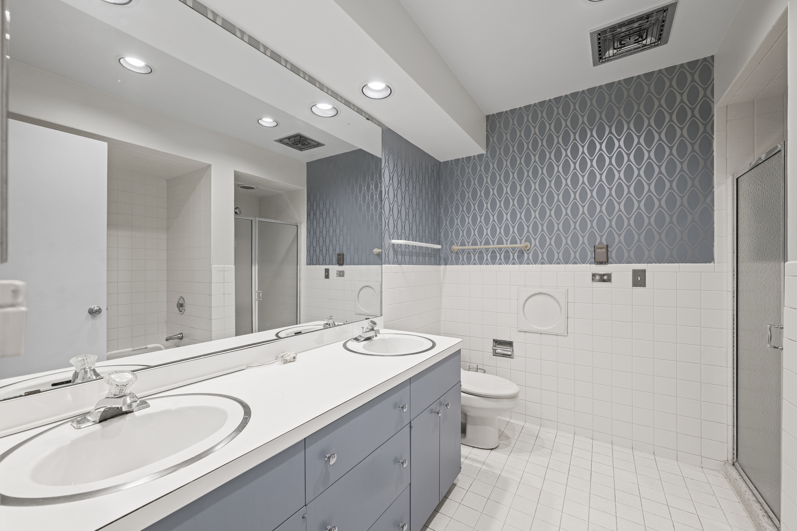 1125 Hohlfelder Road Glencoe, IL 60022 - Photo 15 of 25 a bathroom with a double vanity sink and mirror